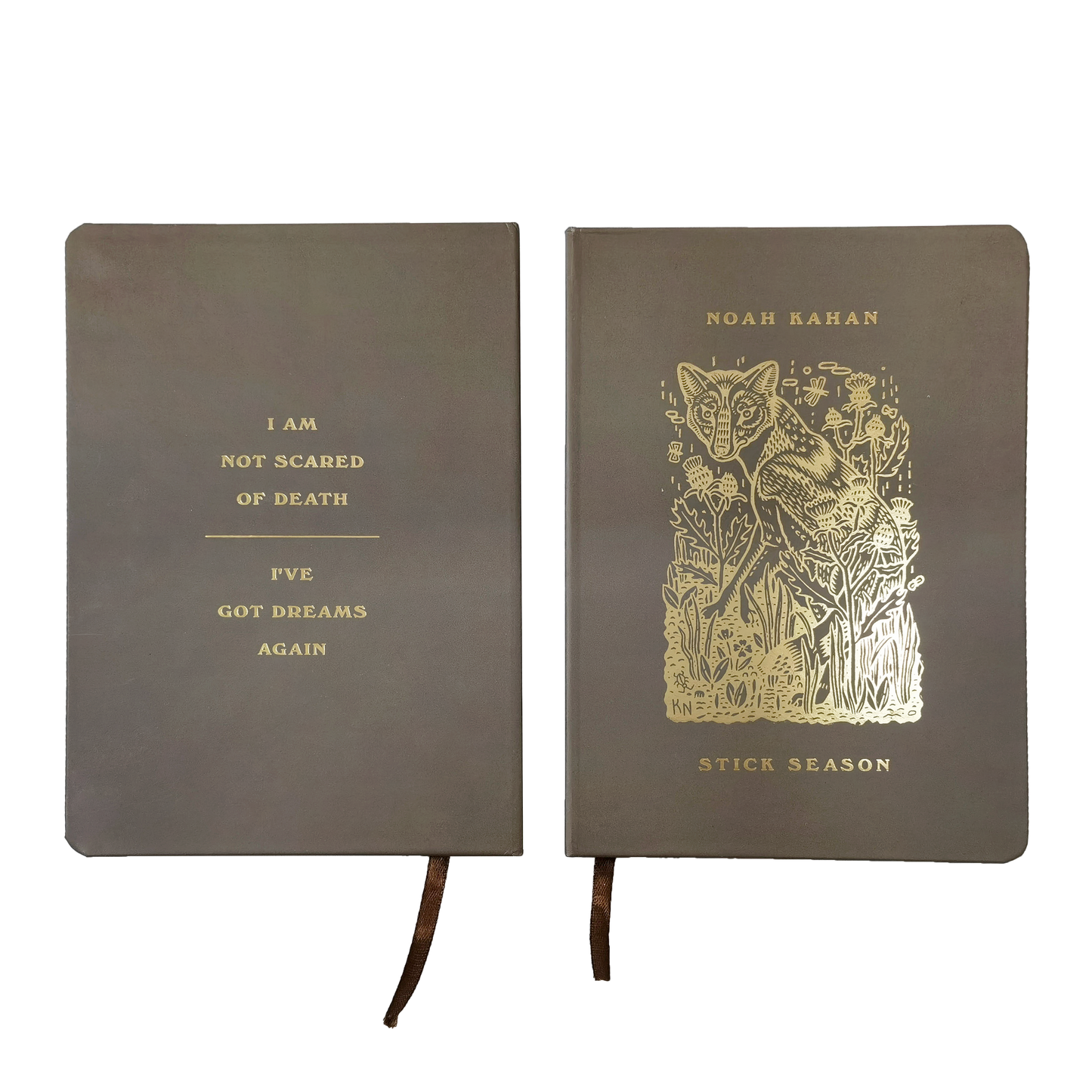 Noah Kahan brown journal with gold foil artwork on front and back. "I am not scared of death / I've got dreams again" on back. Fox and foliage art on front with ribbon bookmark. 