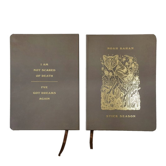 Noah Kahan brown journal with gold foil artwork on front and back. "I am not scared of death / I've got dreams again" on back. Fox and foliage art on front with ribbon bookmark. 